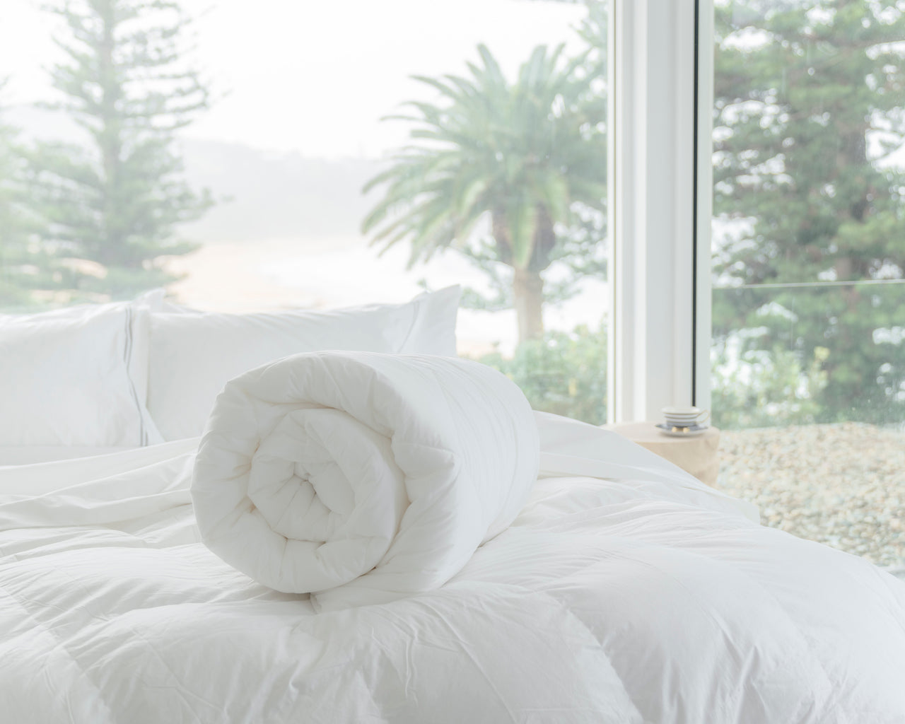 ecoLinen Plant-Wool based quilt rolled on to top of bed